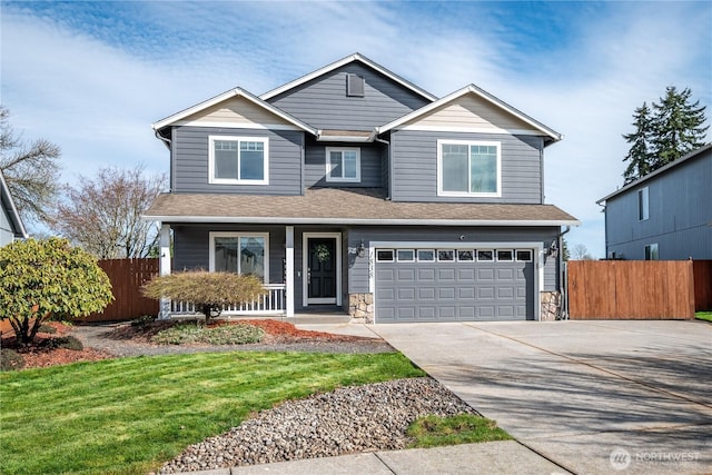 view of front facade featuring a garage, fence, a porch, and concrete driveway