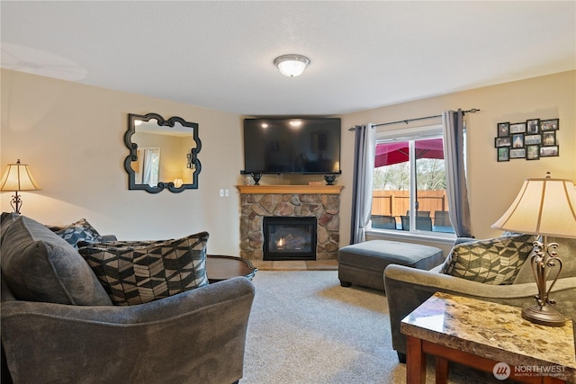 living area featuring carpet and a stone fireplace