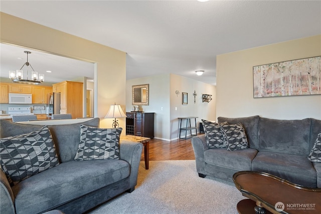 living room with baseboards and an inviting chandelier