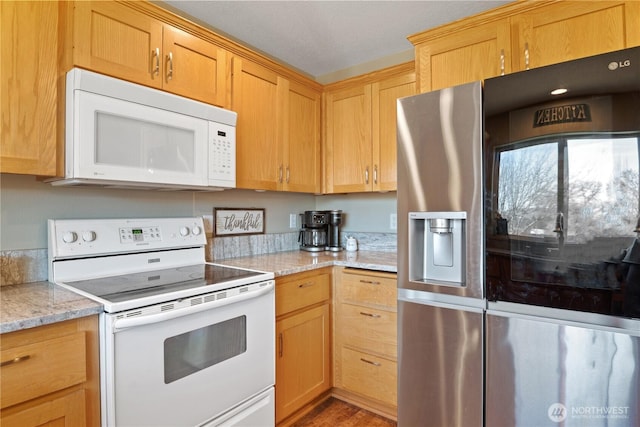 kitchen featuring white appliances, light wood finished floors, and light stone countertops