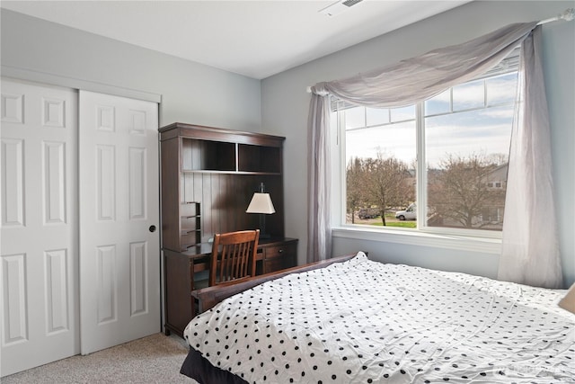 bedroom featuring a closet, carpet, and visible vents