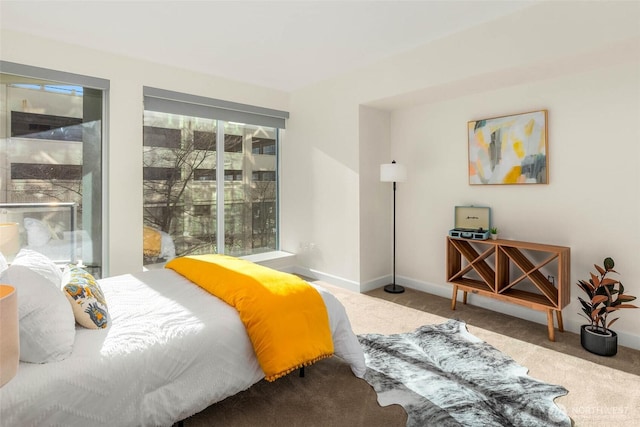 bedroom with carpet floors and baseboards