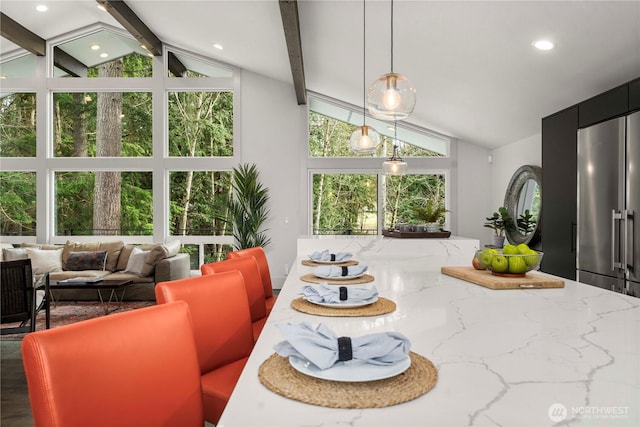 dining room with recessed lighting and lofted ceiling with beams