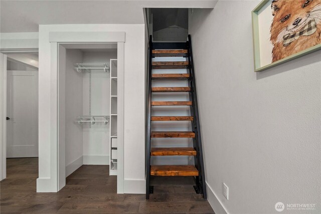 stairs featuring wood finished floors and baseboards