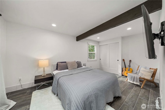 bedroom featuring wood finish floors, beamed ceiling, baseboards, and recessed lighting