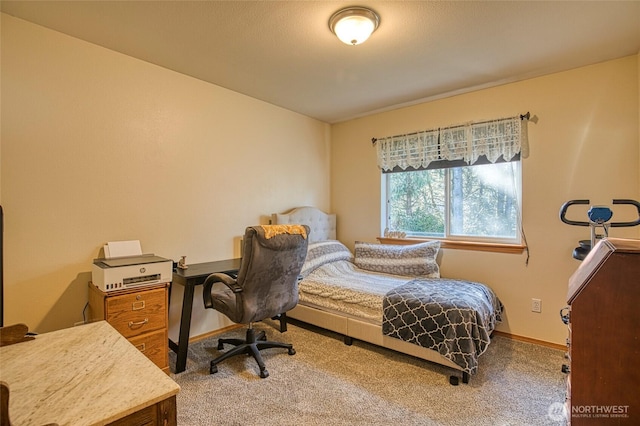 carpeted bedroom featuring baseboards