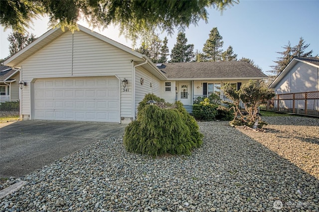 single story home with concrete driveway and an attached garage