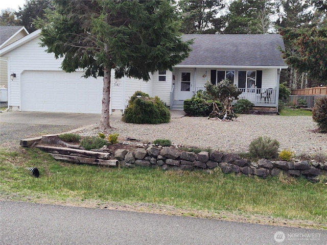 ranch-style home featuring a shingled roof, concrete driveway, covered porch, and an attached garage