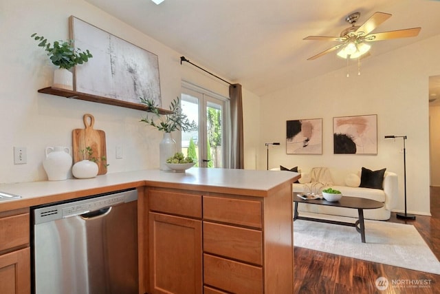 kitchen featuring dishwasher, open floor plan, a peninsula, vaulted ceiling, and light countertops