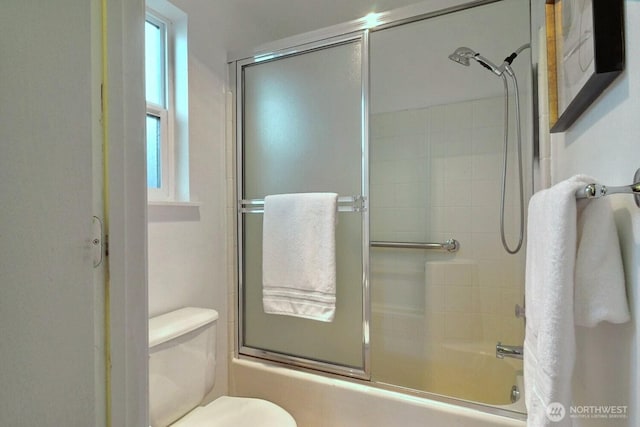 full bath with enclosed tub / shower combo and toilet