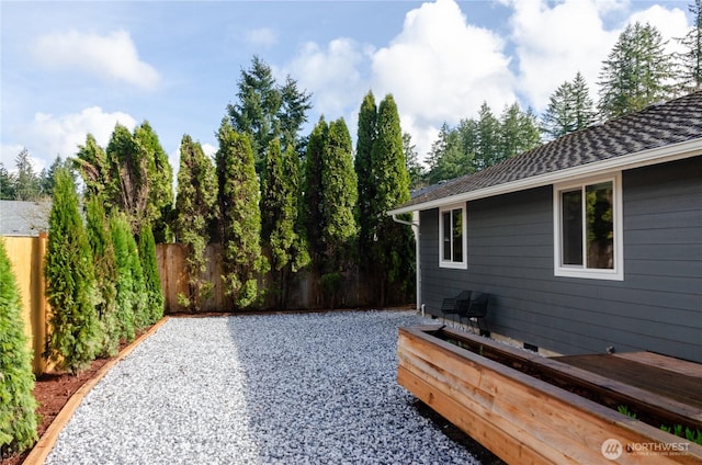 view of yard featuring fence and a wooden deck