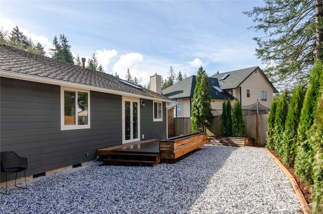 rear view of house featuring crawl space, fence, a wooden deck, and french doors