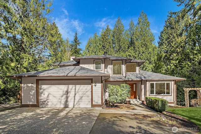 prairie-style house featuring a garage and driveway