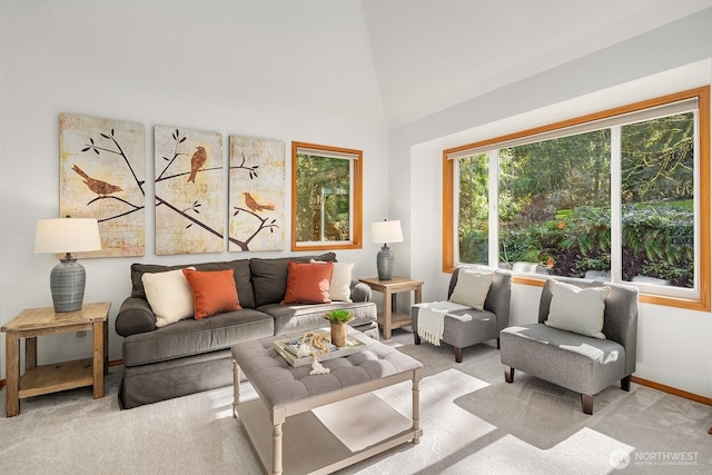 carpeted living area featuring baseboards