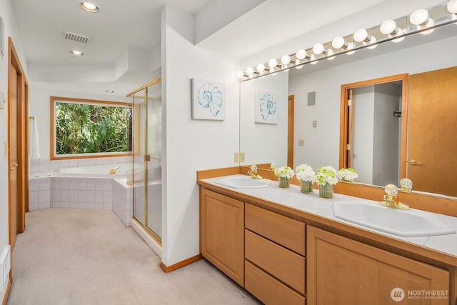 bathroom featuring a stall shower, visible vents, and a sink