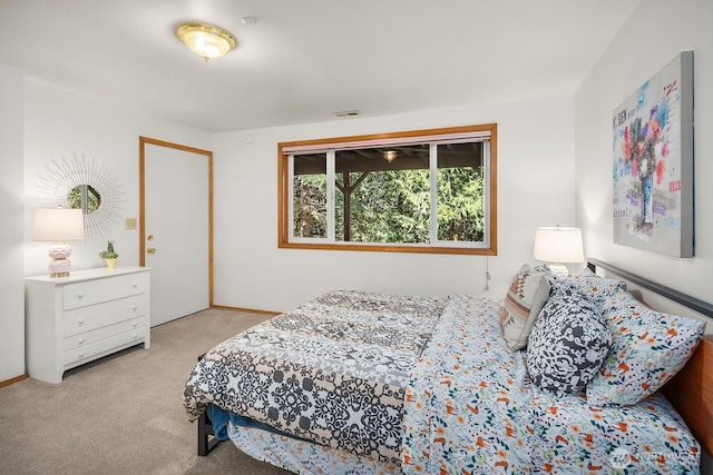 bedroom featuring visible vents and light colored carpet