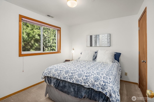 carpeted bedroom featuring visible vents and baseboards