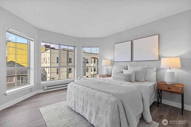 bedroom featuring baseboards and wood finished floors