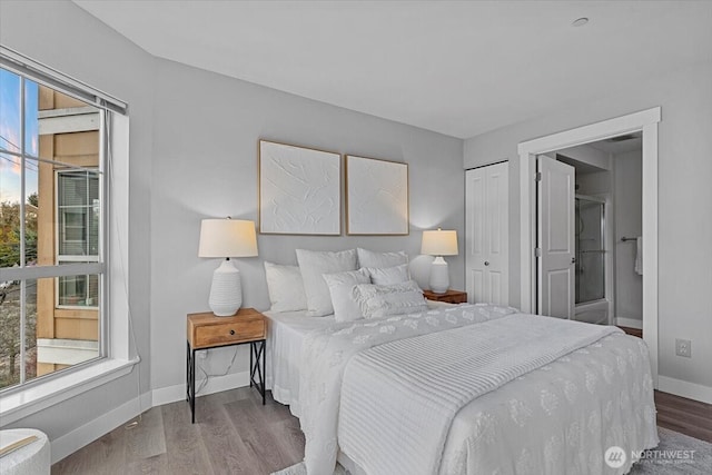 bedroom with wood finished floors and baseboards