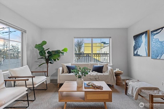 living room featuring a healthy amount of sunlight and baseboards