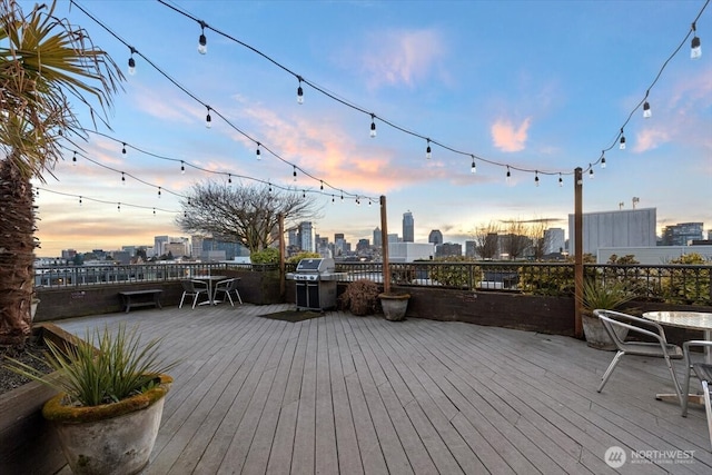 deck at dusk with a city view and a grill