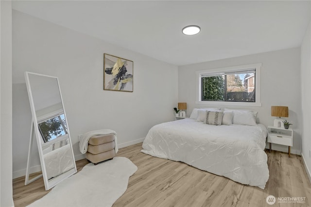 bedroom featuring wood finished floors and baseboards