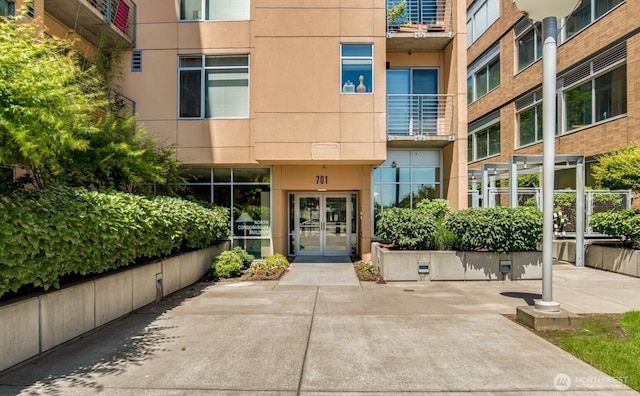 entrance to property with stucco siding and french doors