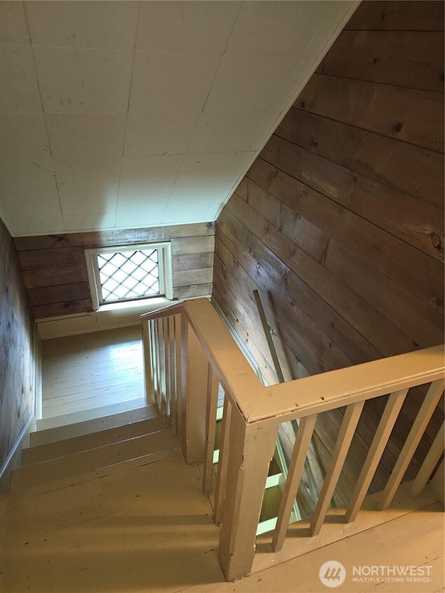 stairs featuring wooden walls