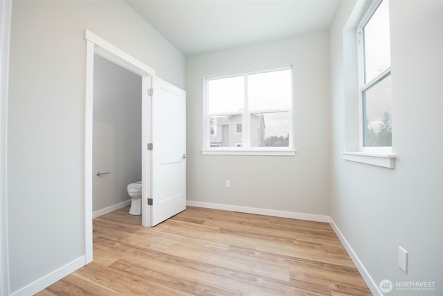 unfurnished bedroom featuring light wood-style floors and baseboards