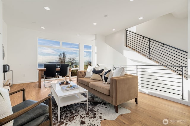 living room with recessed lighting, wood finished floors, and baseboards