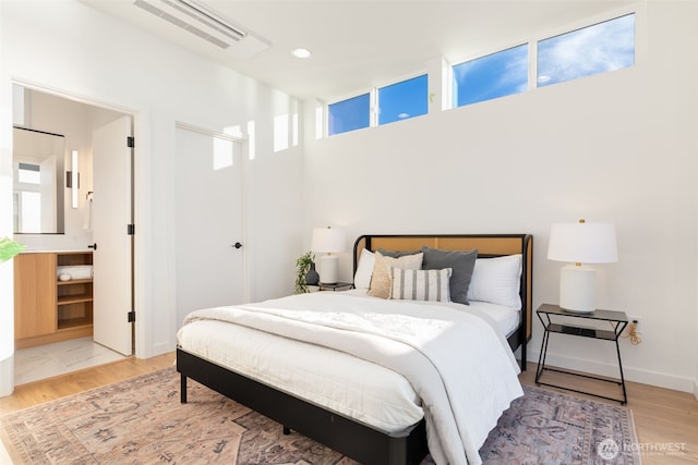 bedroom with recessed lighting, visible vents, baseboards, and wood finished floors