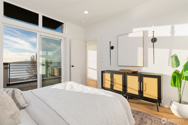 bedroom featuring access to exterior, recessed lighting, and wood finished floors