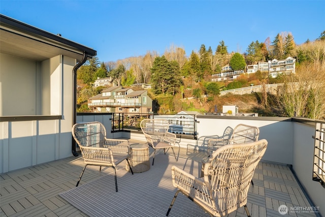 wooden deck with a residential view and an outdoor hangout area