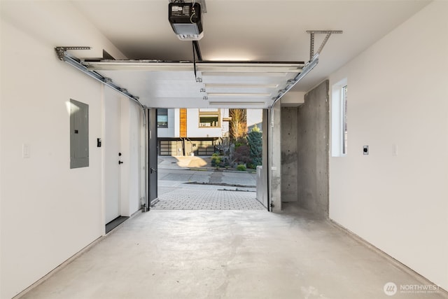 garage with electric panel and a garage door opener