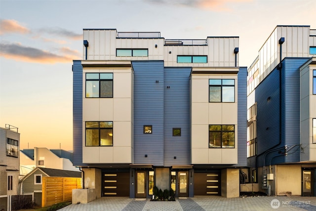 view of front facade featuring stucco siding, driveway, and a garage