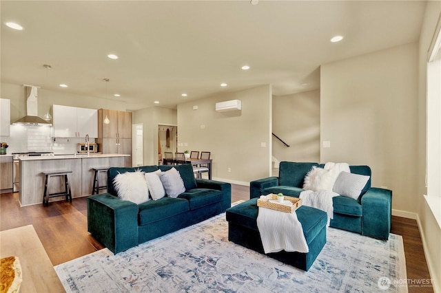 living area featuring dark wood-type flooring, an AC wall unit, and recessed lighting