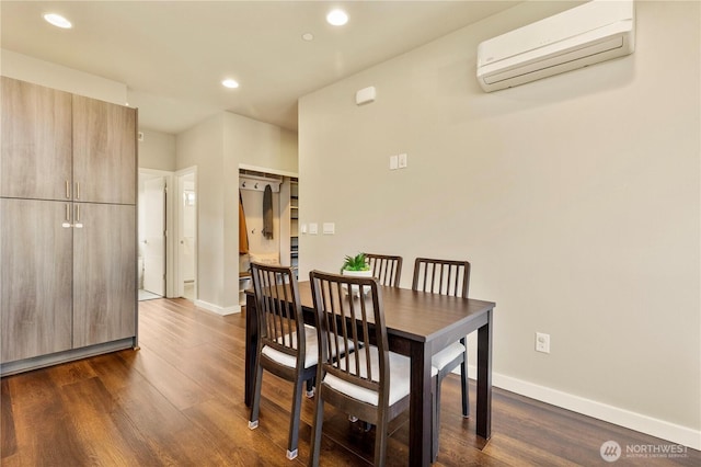 dining room with recessed lighting, baseboards, dark wood finished floors, and a wall mounted air conditioner