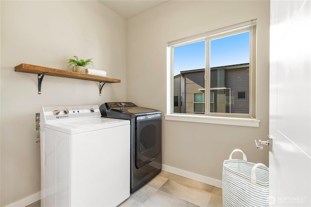 laundry area featuring washer and dryer, laundry area, and baseboards