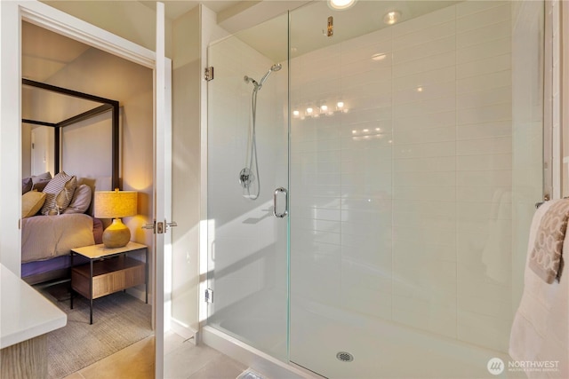 ensuite bathroom featuring a stall shower, tile patterned flooring, and ensuite bath