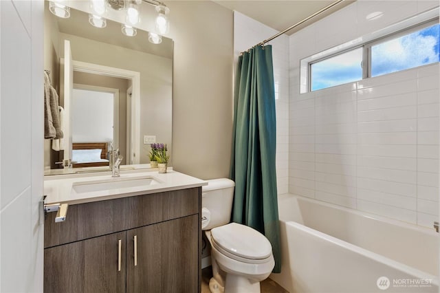 bathroom with shower / bathtub combination with curtain, vanity, and toilet