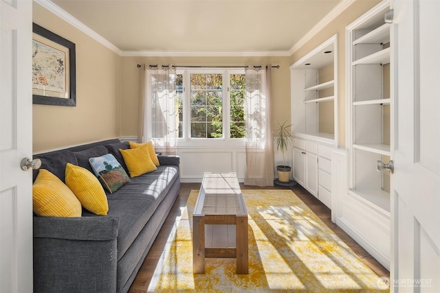 sitting room with crown molding, built in features, and wood finished floors