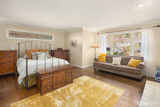 bedroom with ornamental molding, baseboards, and wood finished floors