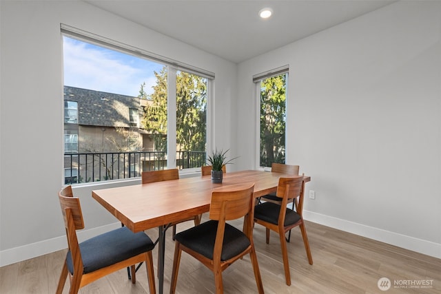 dining area with recessed lighting, baseboards, and light wood-type flooring