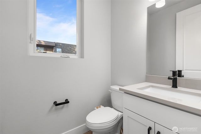 bathroom featuring toilet and vanity