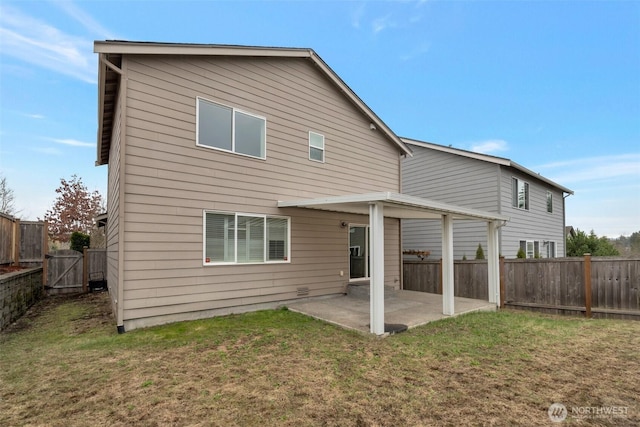 back of property featuring a lawn, a fenced backyard, and a patio area