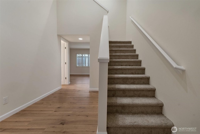 stairs featuring baseboards and wood finished floors