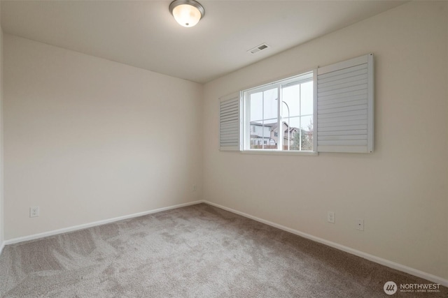 unfurnished room with visible vents, baseboards, and carpet flooring