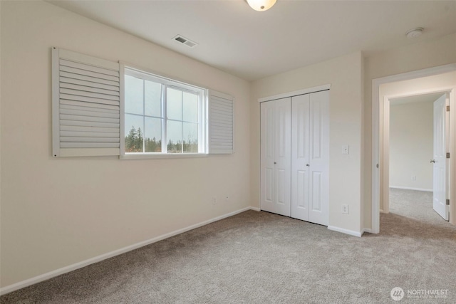 unfurnished bedroom featuring carpet, visible vents, and baseboards