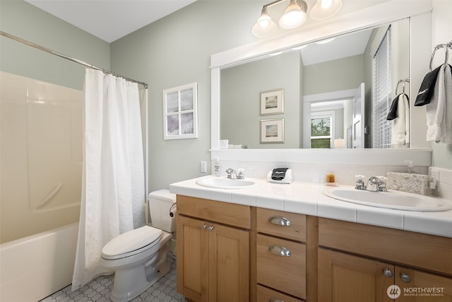 bathroom featuring shower / bath combo, a sink, toilet, and double vanity