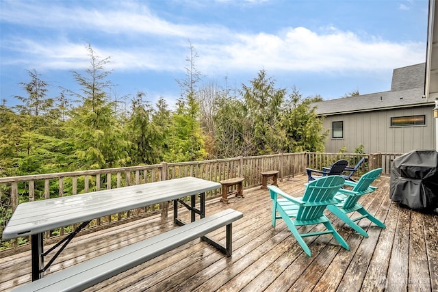 wooden deck featuring outdoor dining area and grilling area